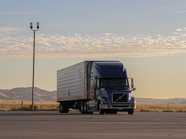A truck travelling along a highway under a wide open sky.
